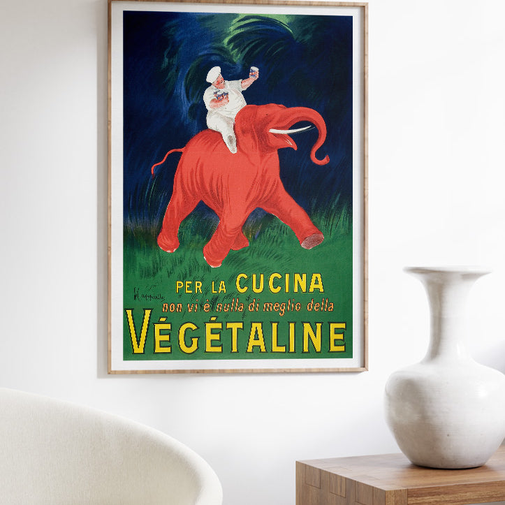 Retro style poster from Leonetto Cappiello featuring an iconic illustration of a chef on a red elephant.